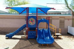 Blue slides with a stretched canvas roof on top for shade.